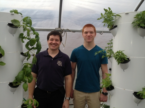Olivet High School Agriscience Teacher and FFA Advisor Doug Pennington and high school student and 4-H member Dalton Humphrey pose next to hydroponic garden structures. Photo courtesy of Christine Sisung.