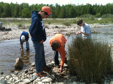 Students exploring the shore in Thompson's Harbor State Park in Michigan.