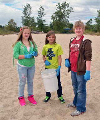 Students doing Adopt-A-Beach clean up image.