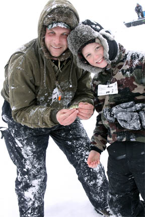 Father and son ice fishing in Michigan image.